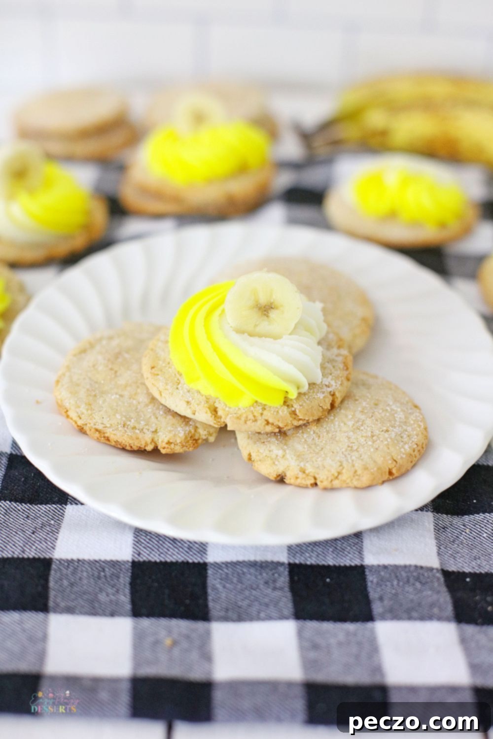 Image of frosted banana cookies on a white dessert plate