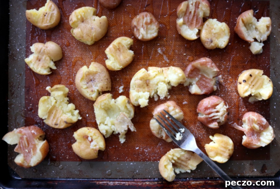 Plated crispy smashed potatoes with fresh herbs