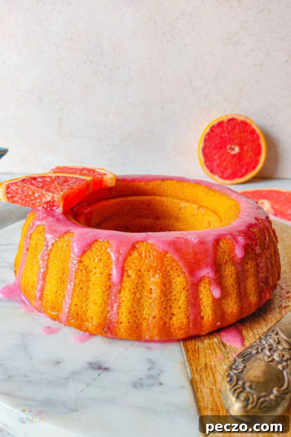 Angle image of blood orange cake glazed with covered in blood orange icing