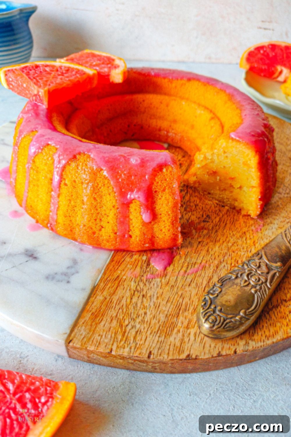 Close up image of orange bundt cake made with blood oranges and glazed