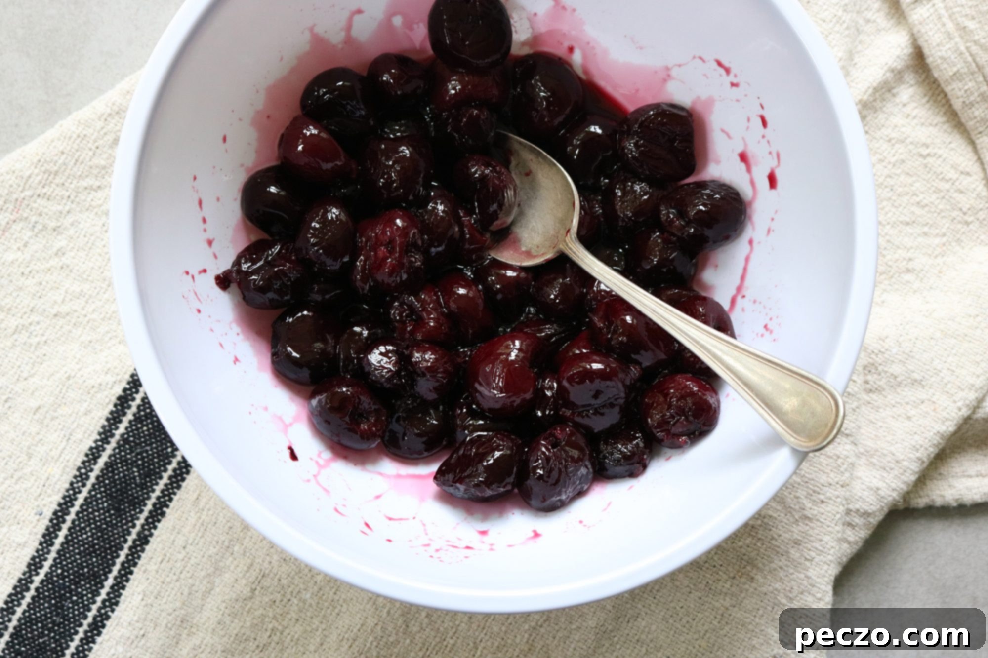 Fresh cherries in a bowl on a wooden table