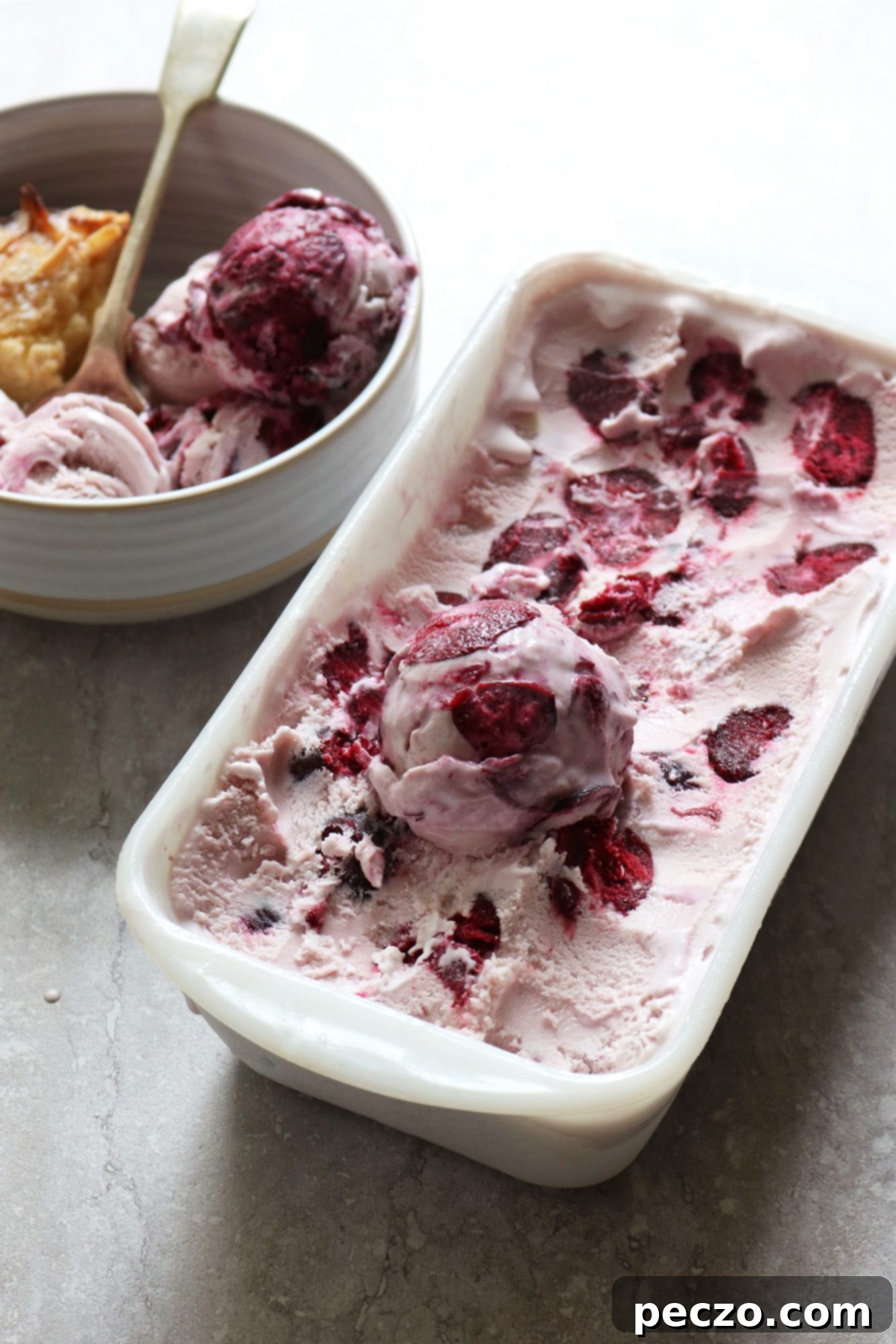 Roasted cherry ice cream in a bowl with a spoon