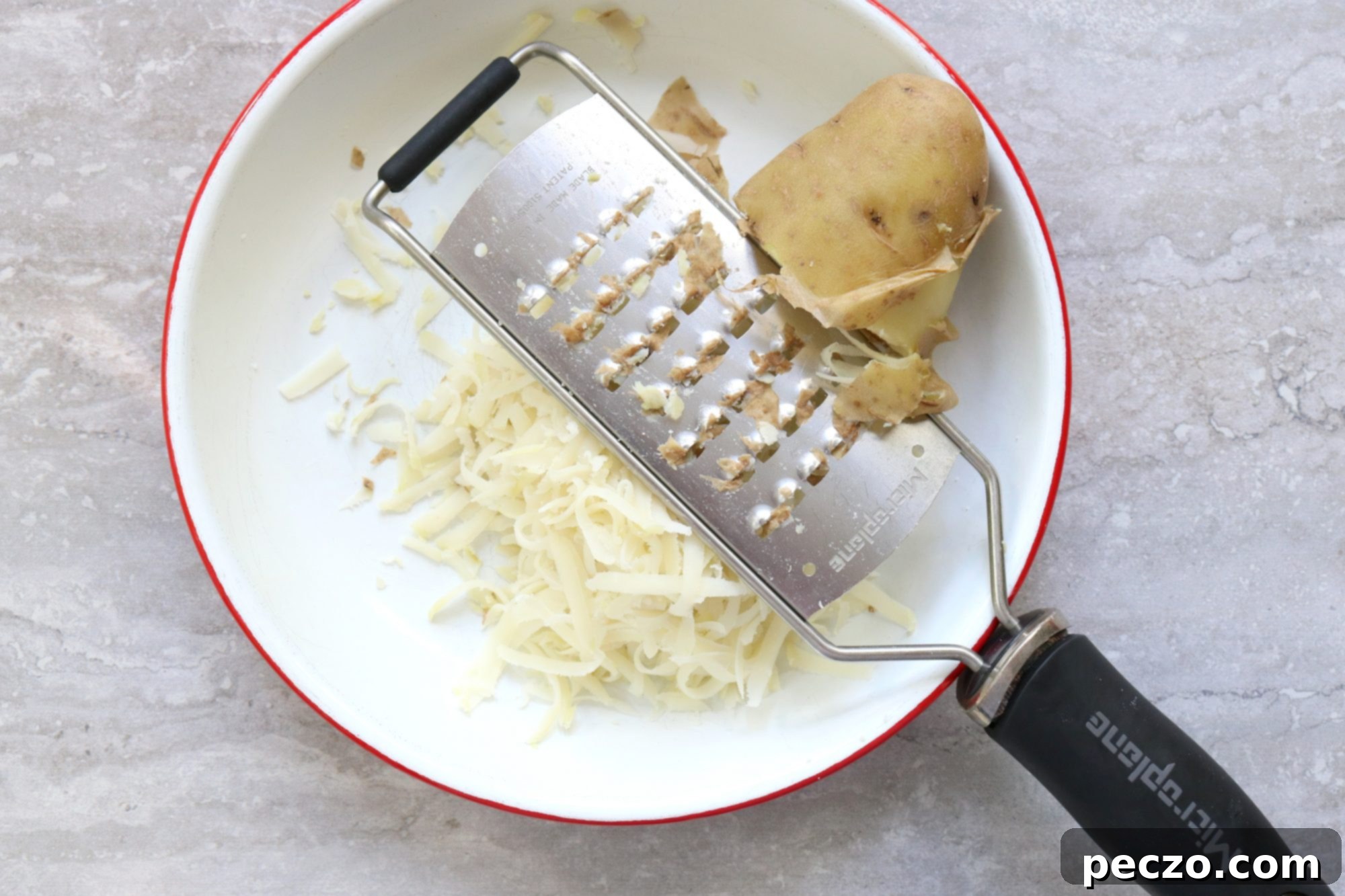 Two halves of Jarlsberg Rösti revealing the melted cheese center, on a wooden surface.