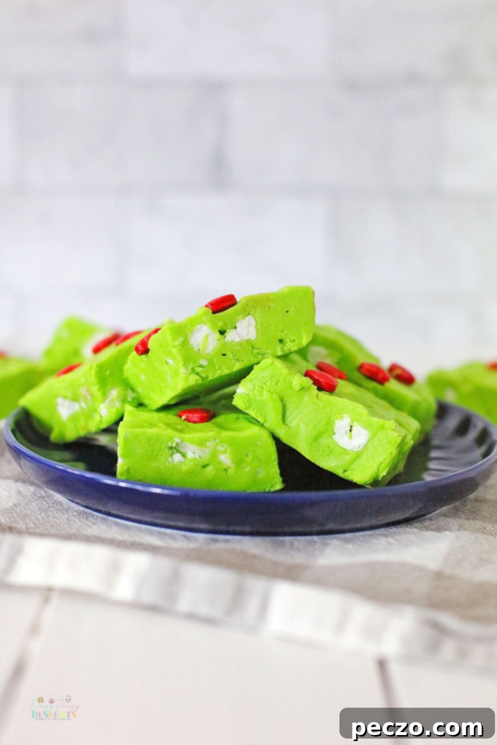 Green Christmas fudge with red heart candy and white marshmallows
