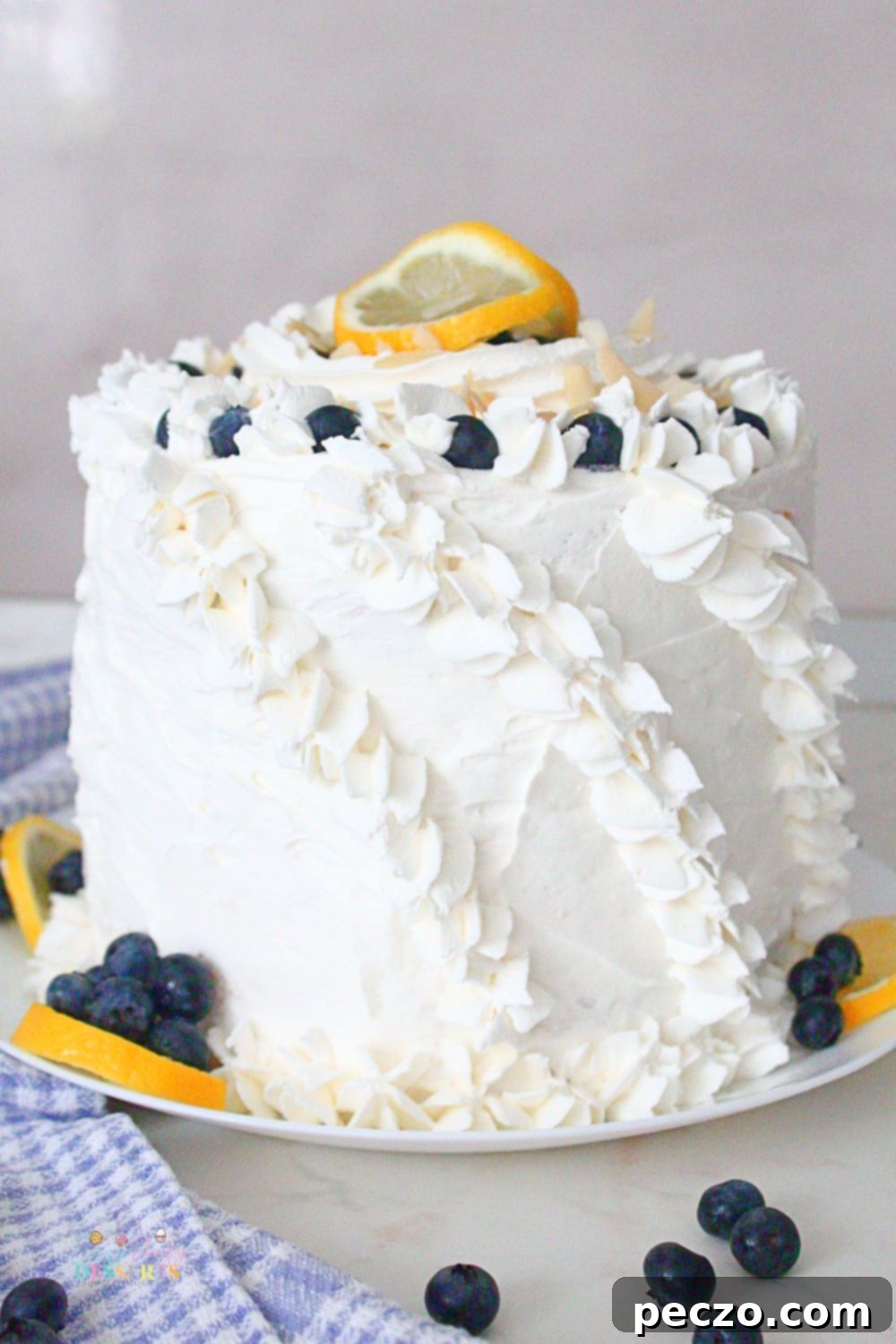 Lemon blueberry cake on a cake plate, ready to be served