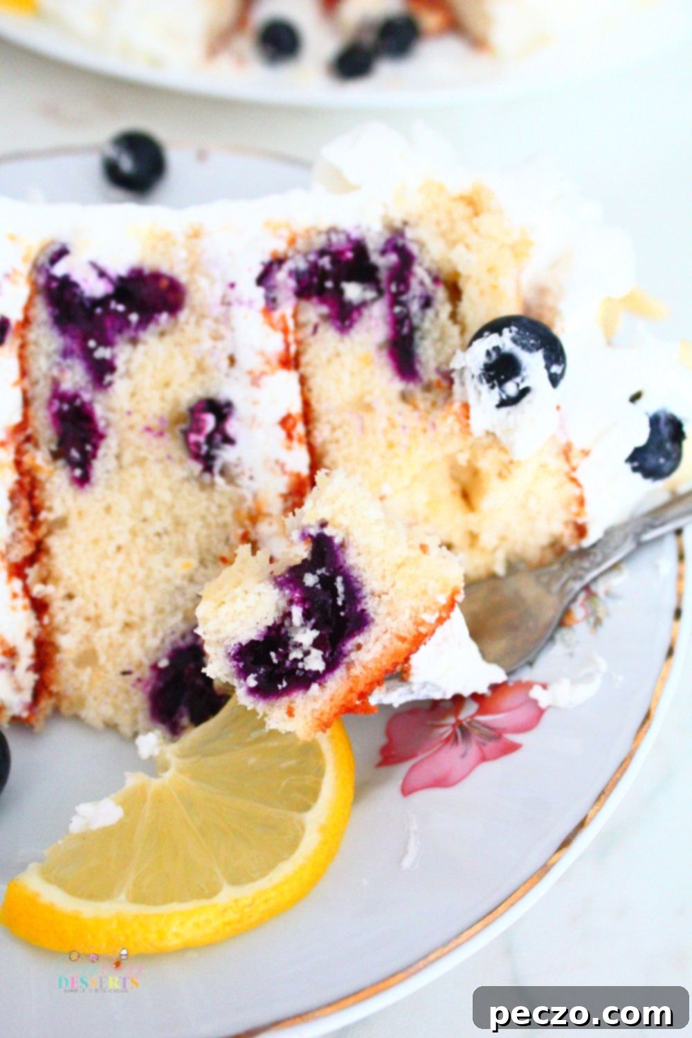 Close up image of a bite of easy lemon blueberry cake on a fork