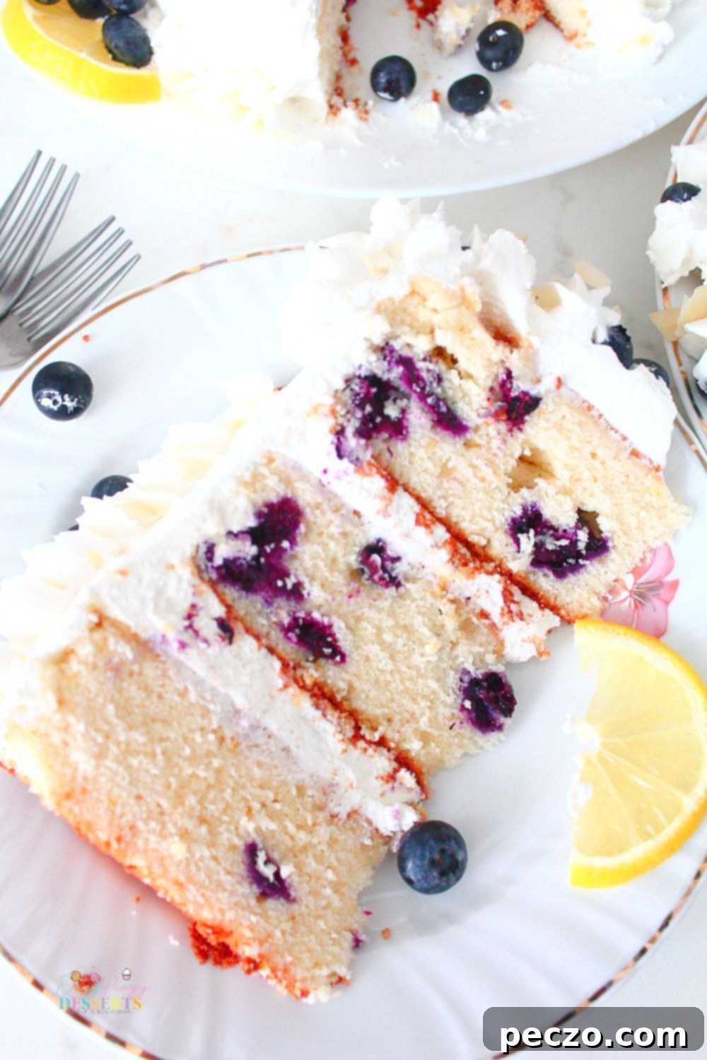 A slice of simple lemon blueberry cake recipe on a white plate