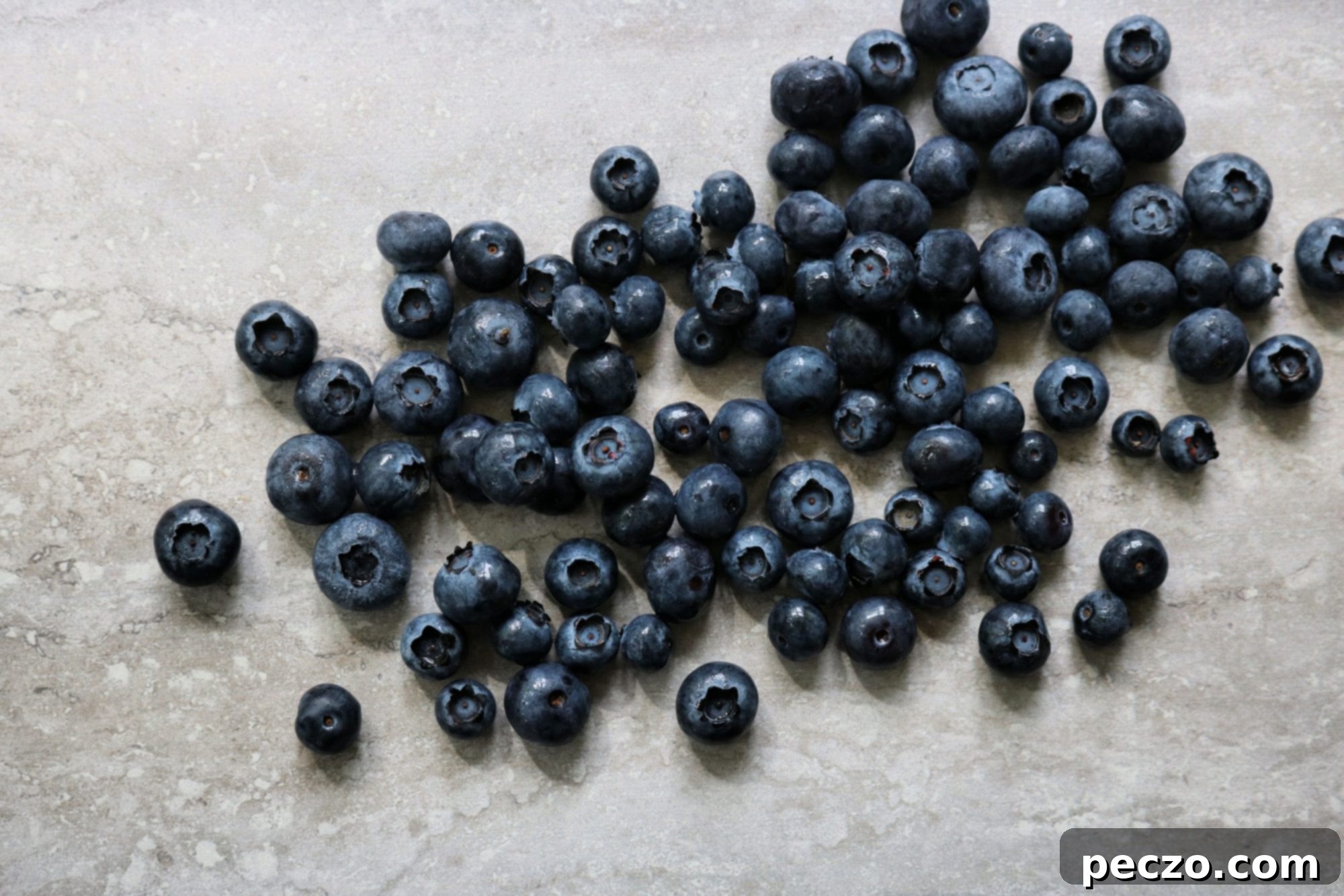 A close-up of the batter for blueberry corn fritters being prepared in a bowl.