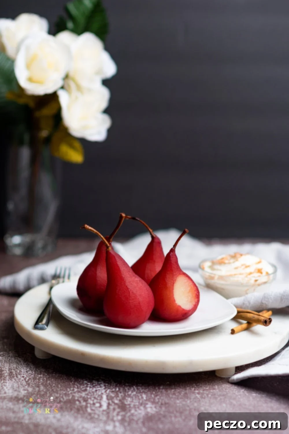 Image of pears in wine dessert on a white serving plate