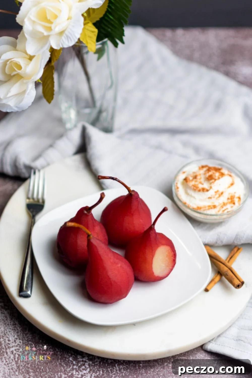 Image of pears in red wine on a white serving plate