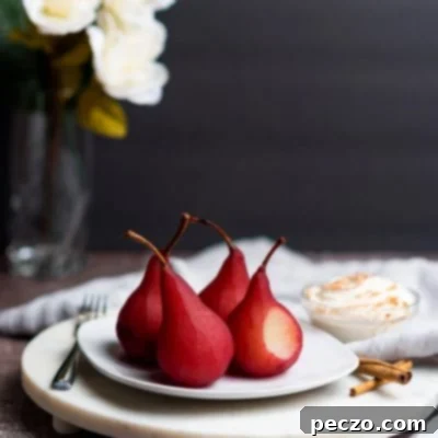 Image of pears in wine dessert on a white serving plate