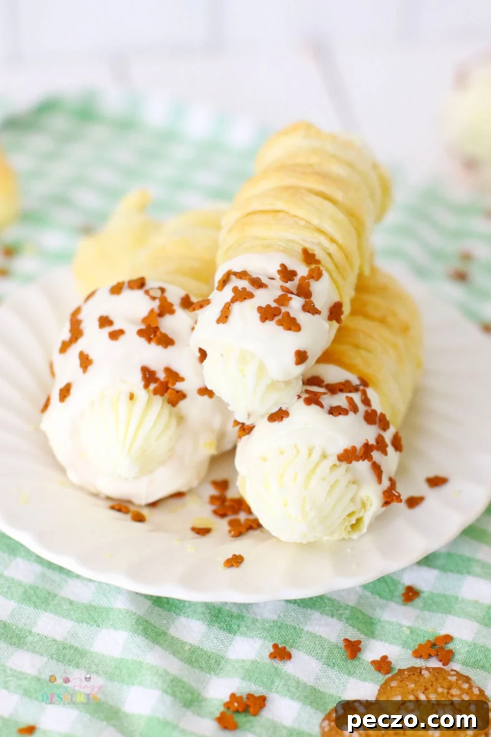 Four air-fried cream horns elegantly arranged on a serving plate, each filled with gingerbread-flavored cream and topped with festive sprinkles.