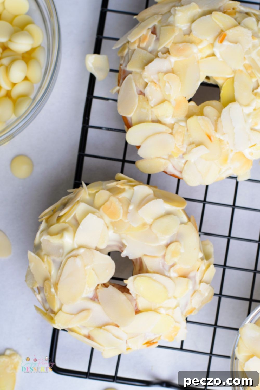 Over head image of homemade yeast donuts with white chocolate glaze and shaved almonds