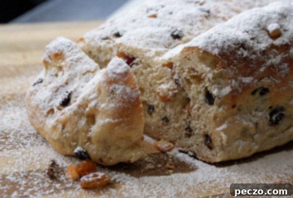 Delicious freshly baked Stollen, a traditional German Christmas bread, dusted with powdered sugar and ready to be enjoyed.