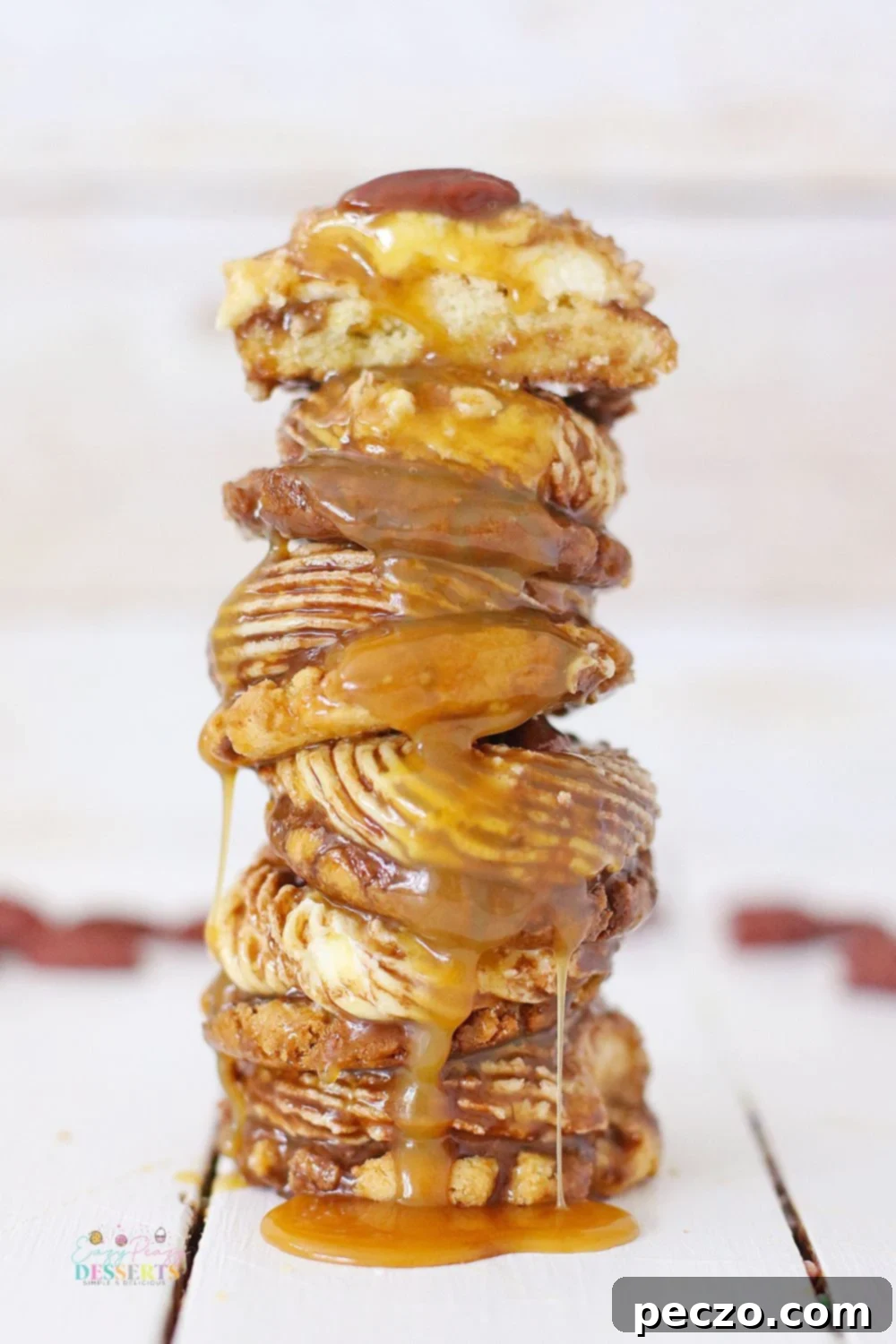 Stack of pecan turtle cookies with caramel sauce
