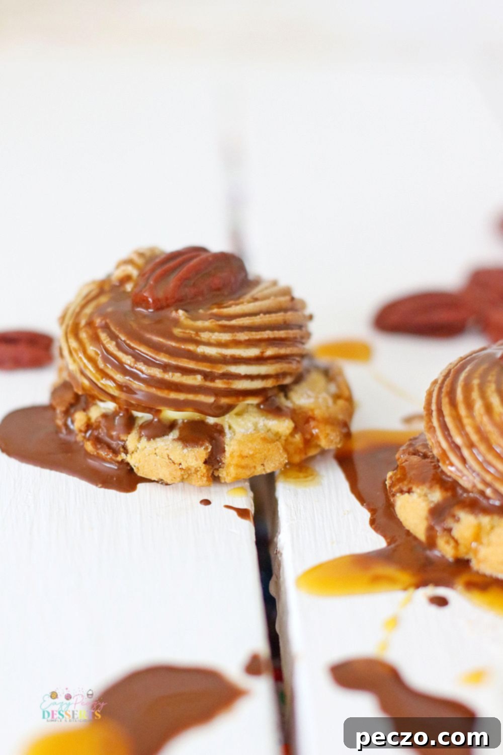 Close up image of a chocolate turtle cookie with pecan and caramel sauce