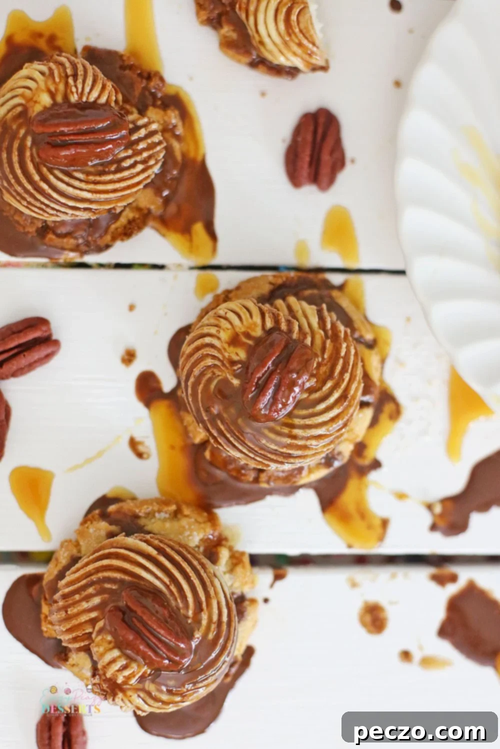 Overhead image of turtle cookies with caramel and chocolate sauce