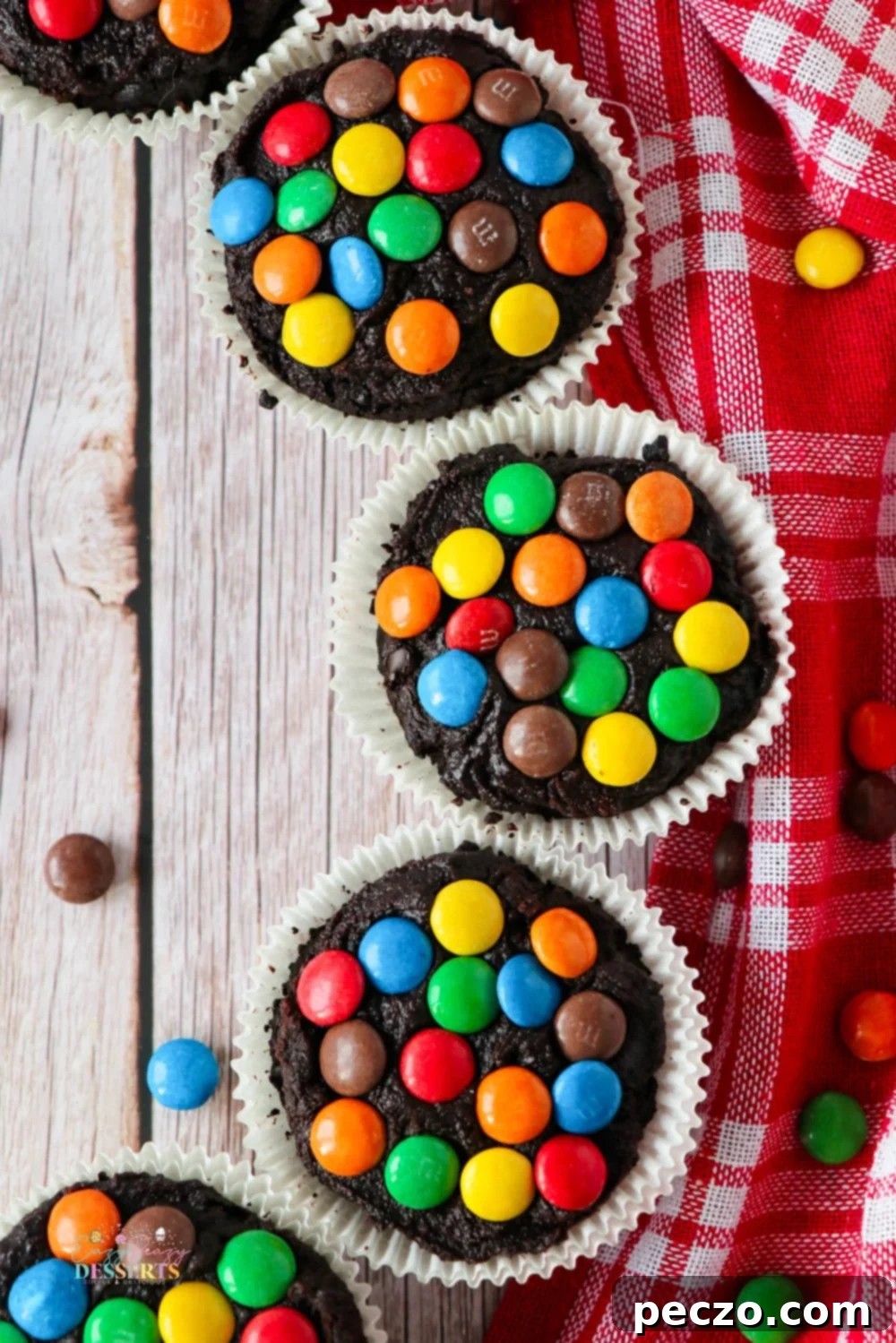 Batch of rich chocolate brownie cupcakes with no frosting, cooling in their paper liners