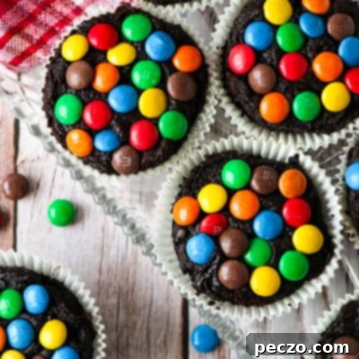 Overhead view of homemade chocolate M&M cupcakes with creamy frosting