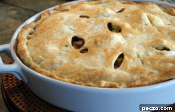 Château Frontenac Turkey Pot Pie with Sausage and Mushrooms 1 A golden, flaky-crusted pot pie, fresh from the oven, ready to be served for a comforting meal.