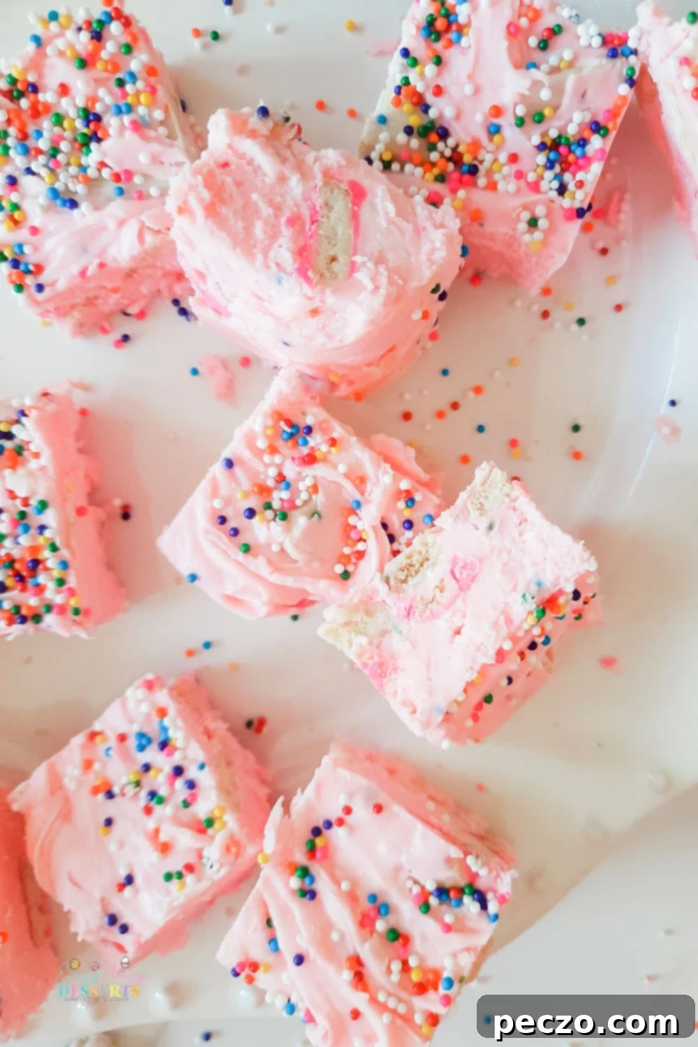 Over head image of a few strawberry fudge bars with sprinkles and cookies