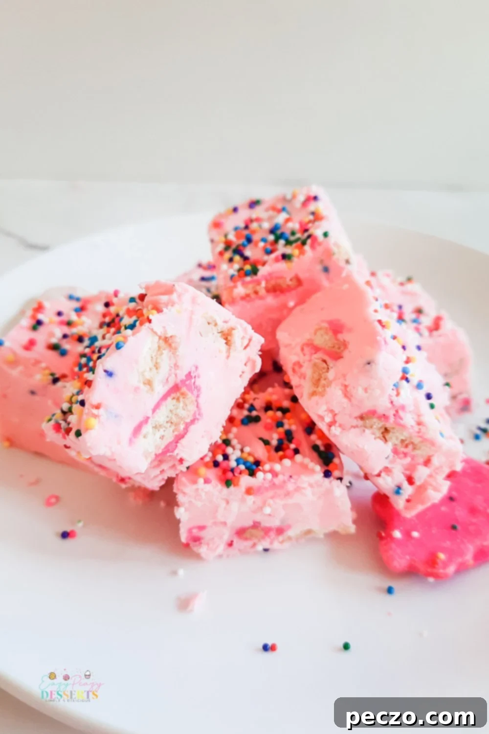 A few squares of funfetti fudge with strawberry frosting, sprinkled and circus cookies