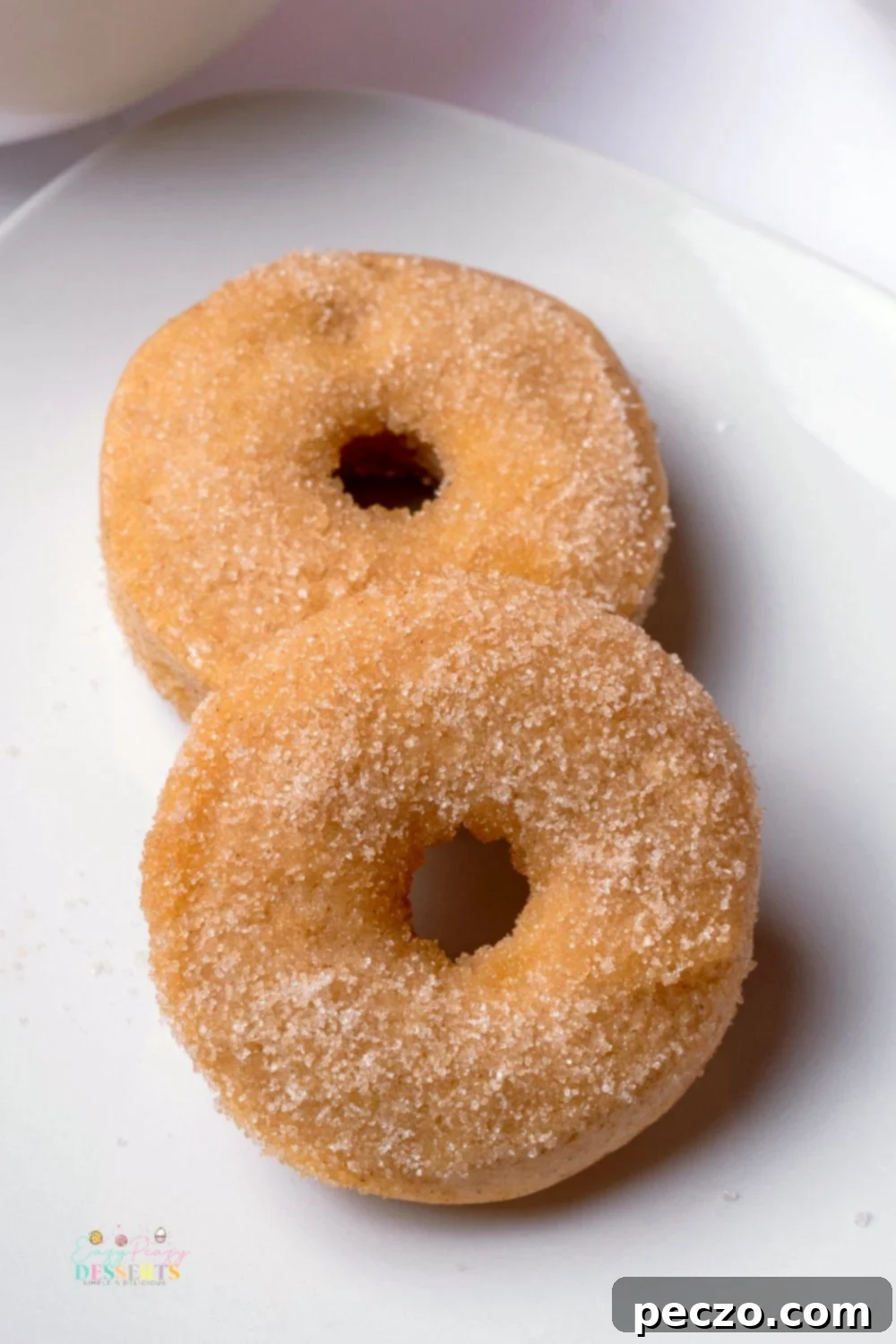 Close up image of caked cinnamon sugar donuts