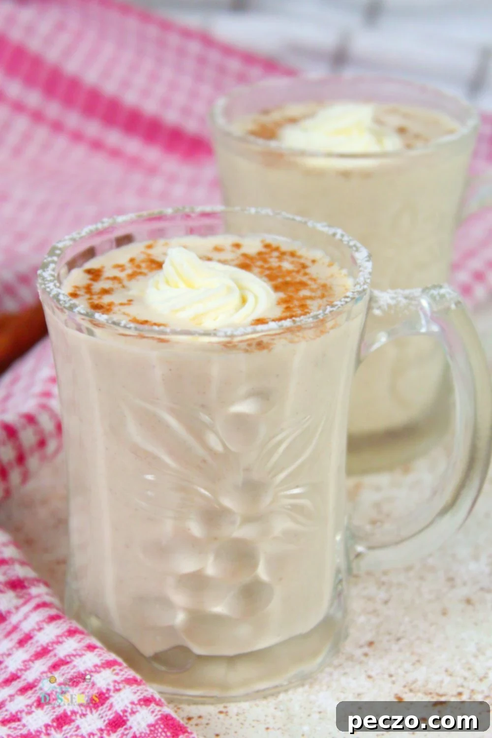 Non alcoholic eggnog in a mug decorated with whipped cream