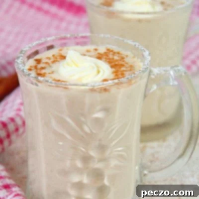 Non alcoholic eggnog in a mug decorated with whipped cream