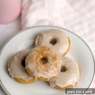 Overhead image of vegan pumpkin donuts with maple glaze, ready to serve.