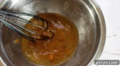 Folding wet and dry ingredients together to form vegan donut batter.