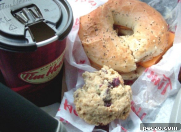 person eating in car, quick snack, on-the-go meal