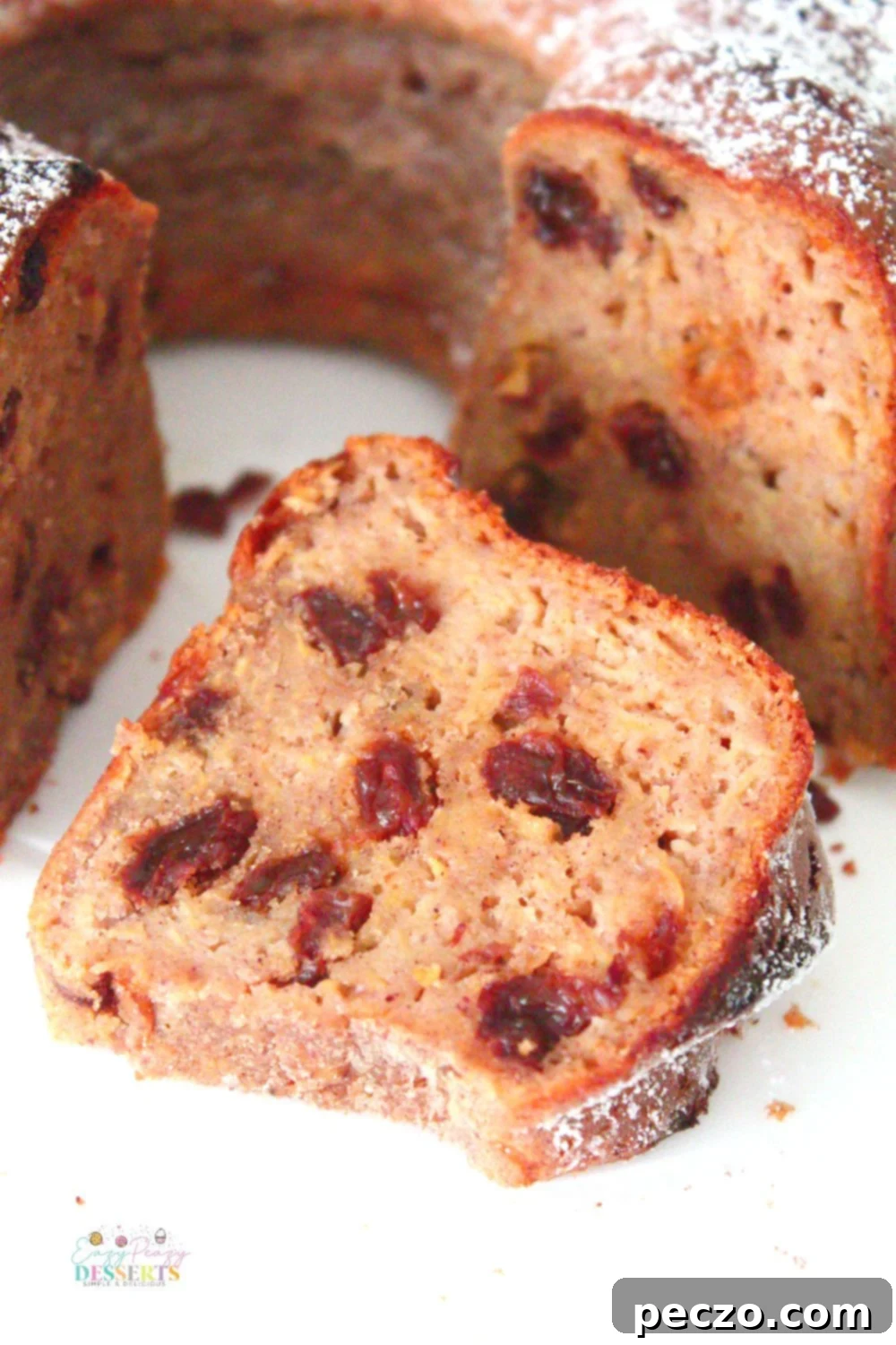 Image of a slice of apple cinnamon bundt cake with raisins