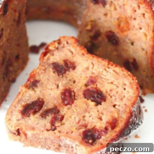 Image of a slice of apple cinnamon bundt cake with raisins