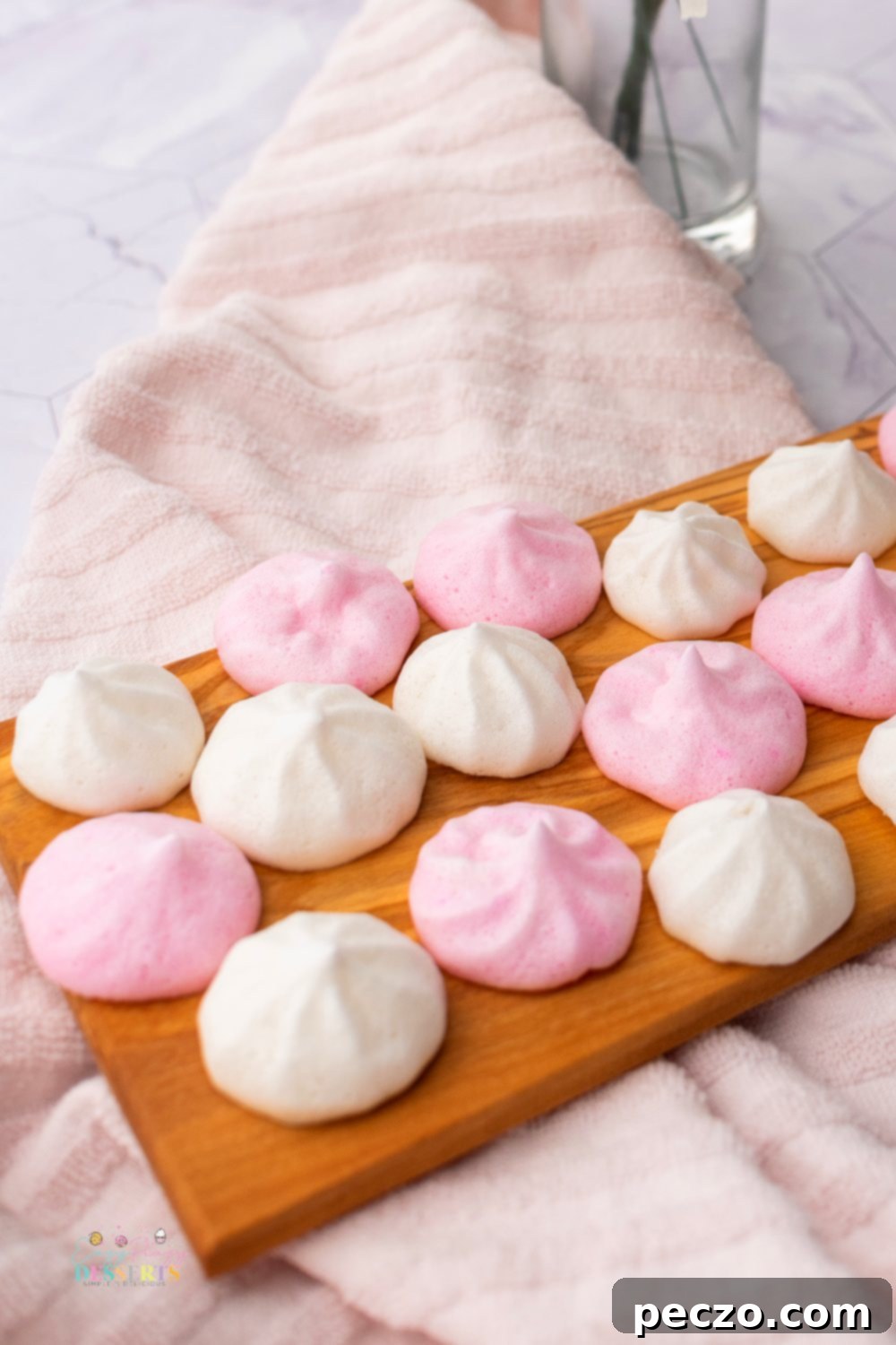 Close up image of vegan meringues in pink and white colors