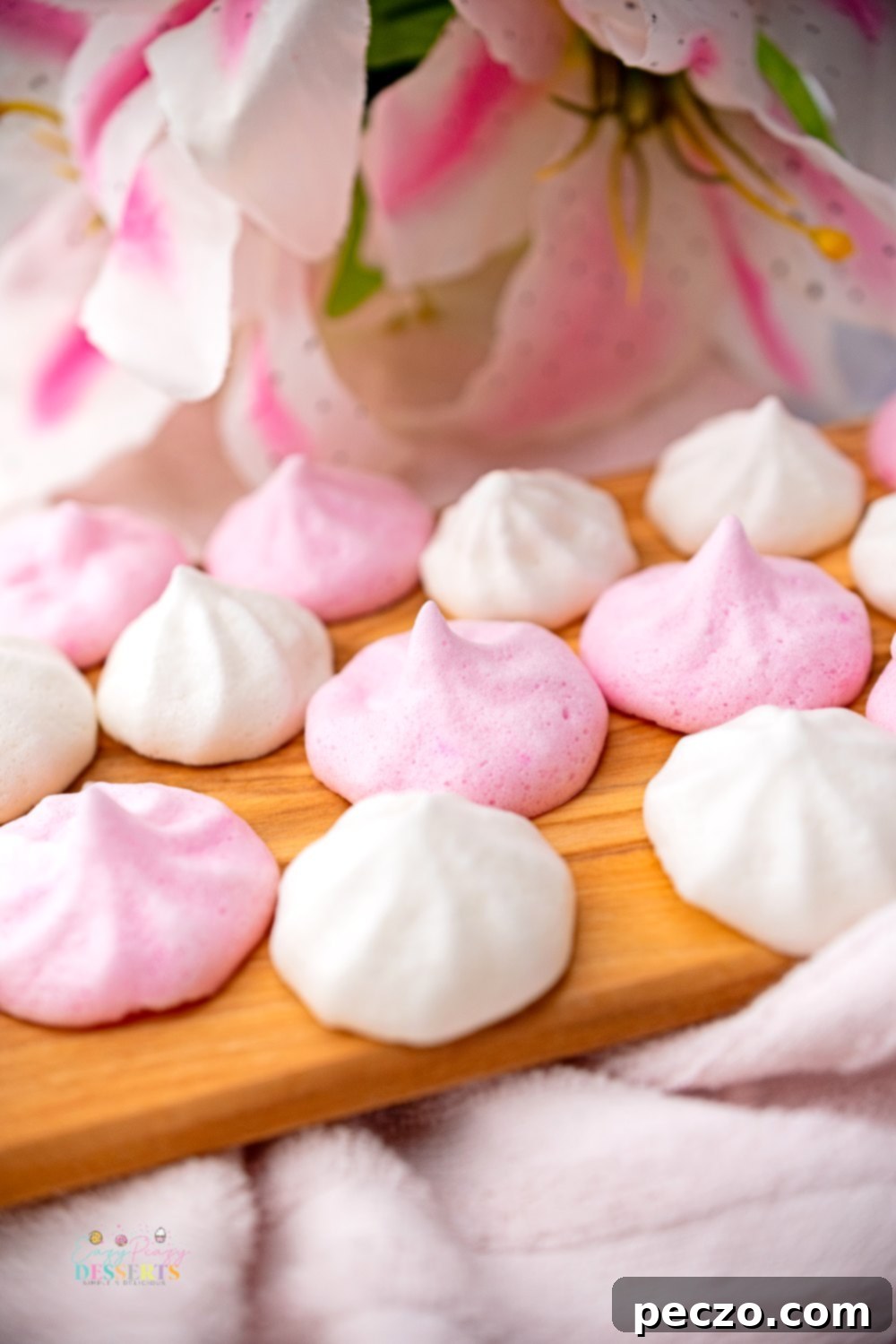 Close up image of pink and white vegan meringue cookies