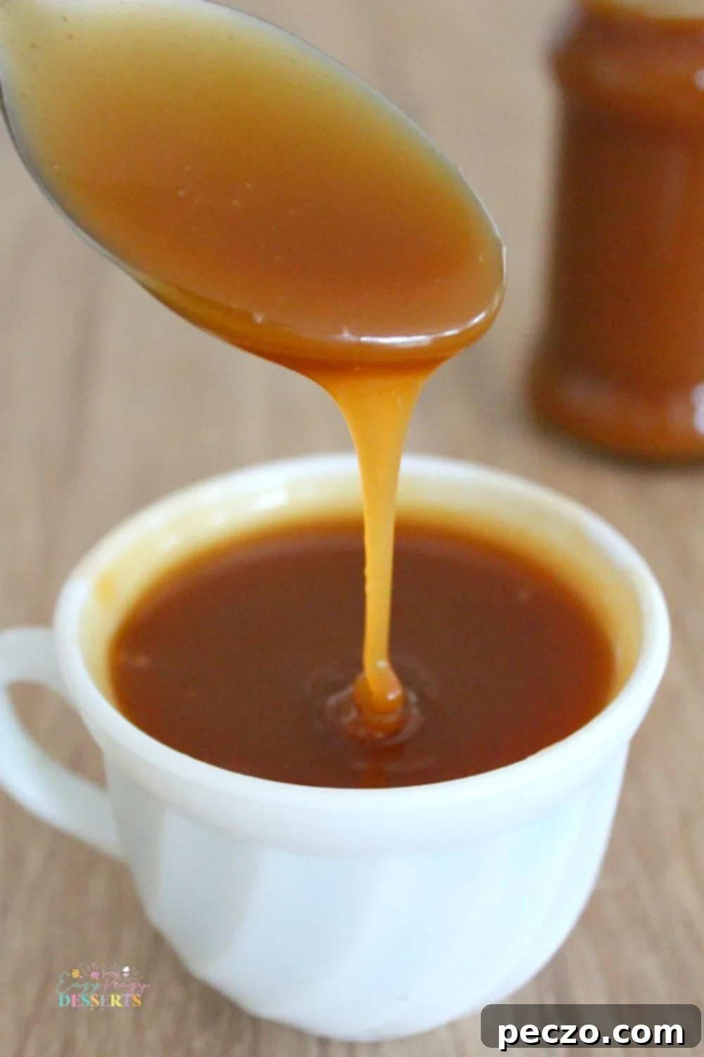 Close up image of easy homemade salted caramel sauce glistening in a bowl, perfect for desserts