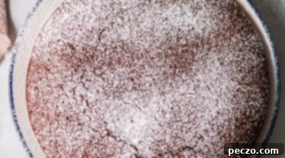 Dusting chocolate cake with powdered sugar