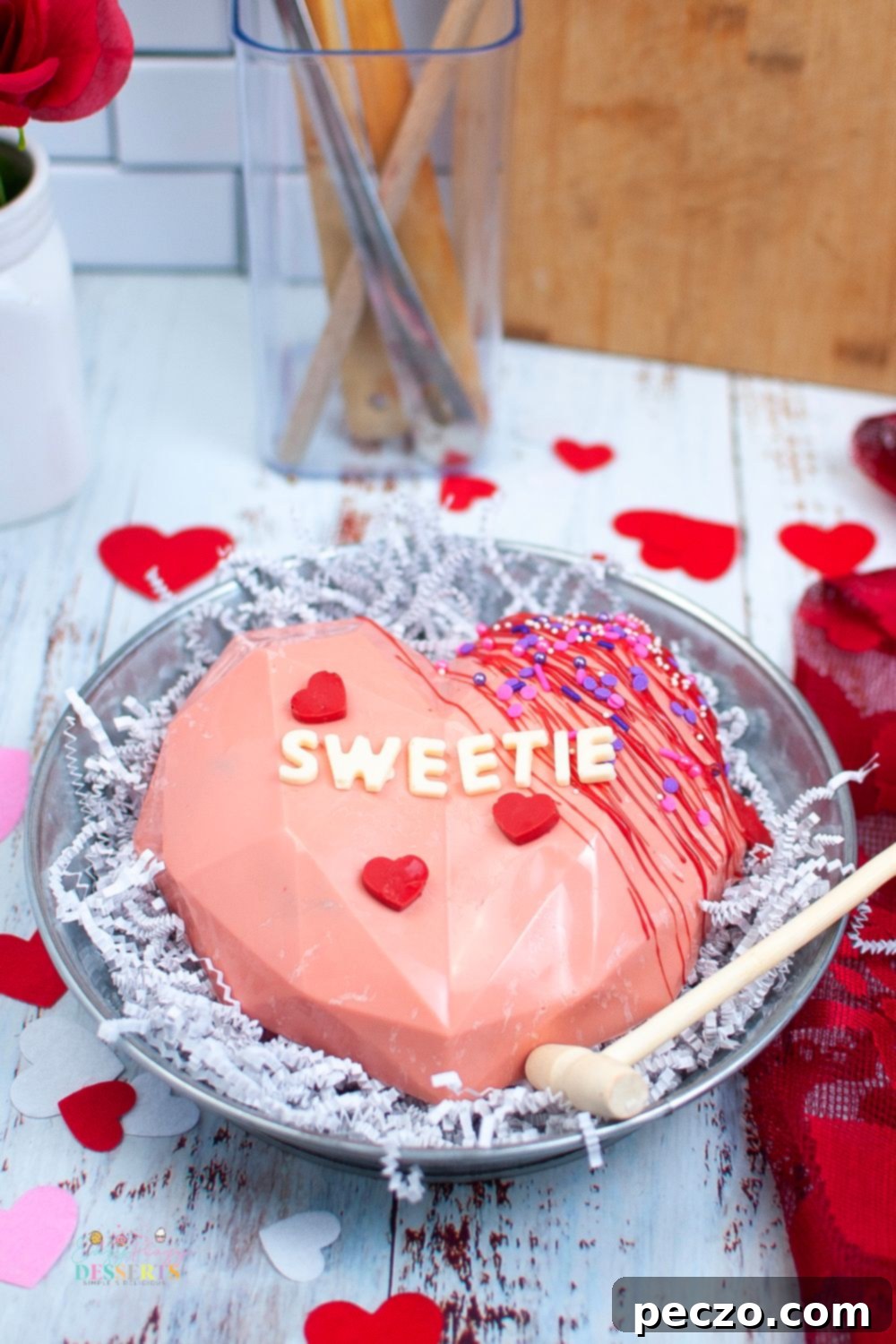 Close-up image of a breakable chocolate heart for Valentine's day, showing the textured surface and decorations.