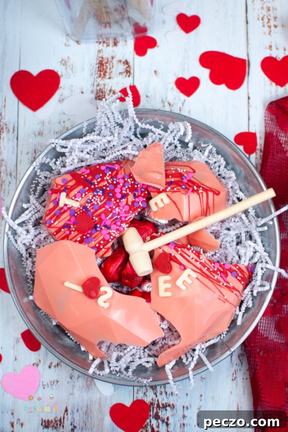 Over head image of heart shaped breakable chocolate for Valentine with various sprinkles