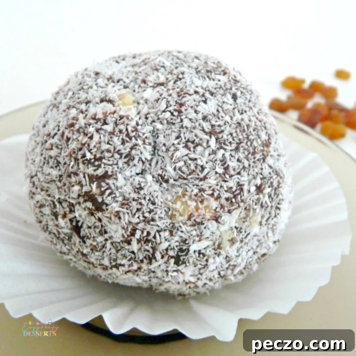 Close up image of a cookie truffle covered in coconut