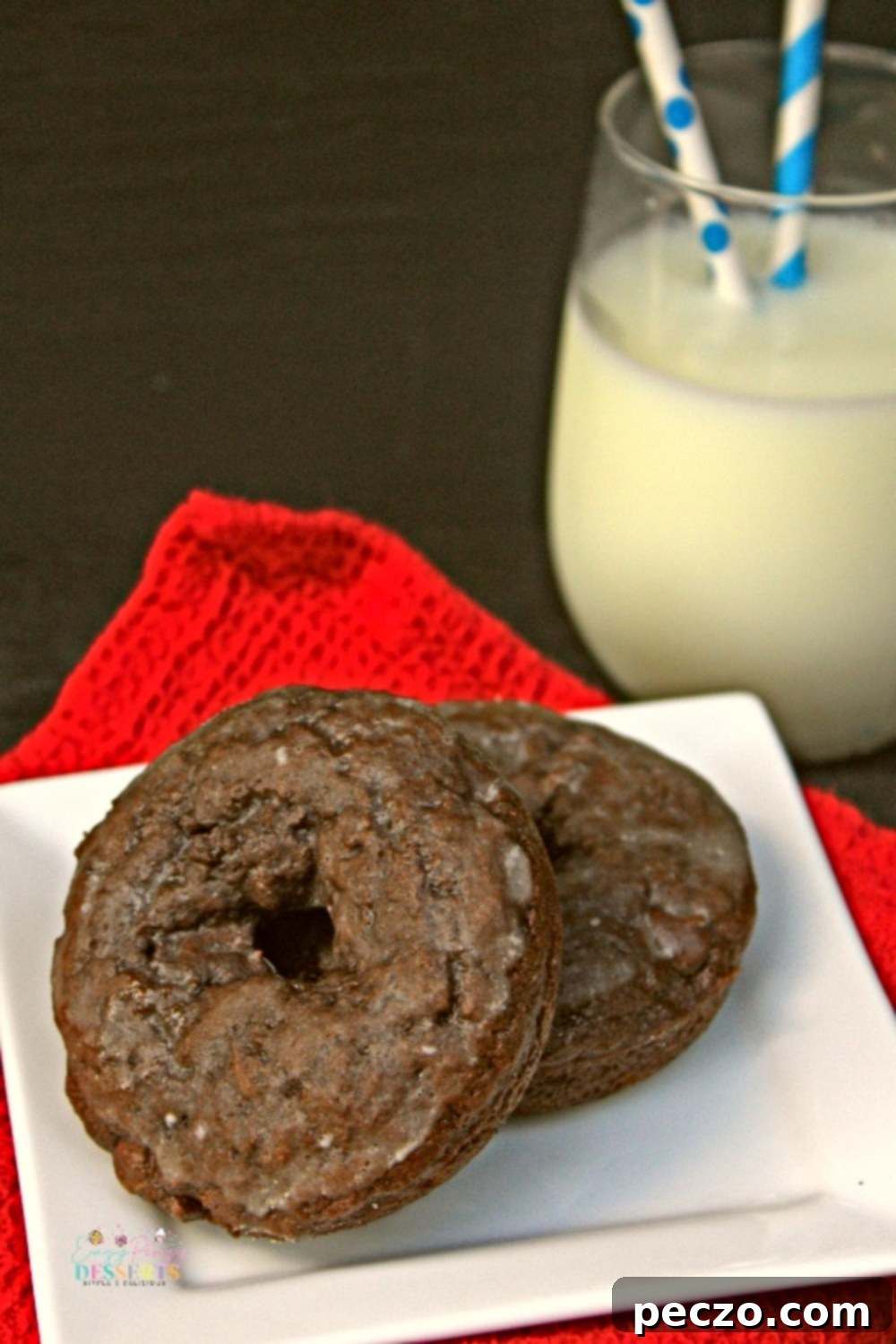 Image of a couple of chocolate chip donuts on a dessert plate