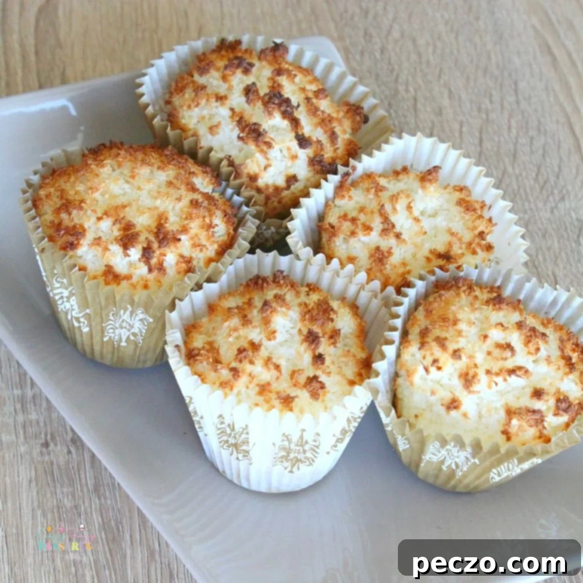 Close-up of freshly baked easy gluten-free coconut muffins on a elegant dessert dish.