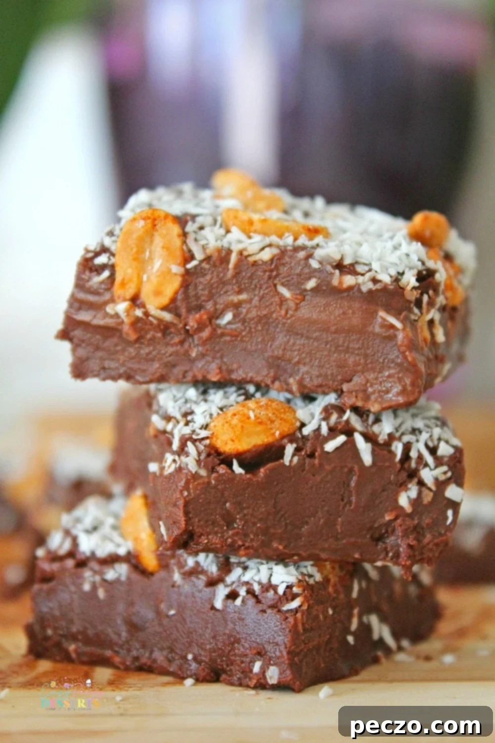 Another view of three squares of luscious 2-ingredient chocolate fudge, ready for serving or enjoyment, with a slight gleam indicating its smooth texture