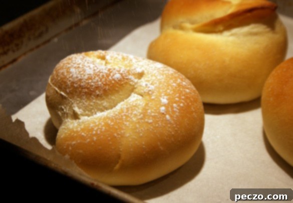 Freshly baked Ensaimadas dusted with powdered sugar, ready to be enjoyed.