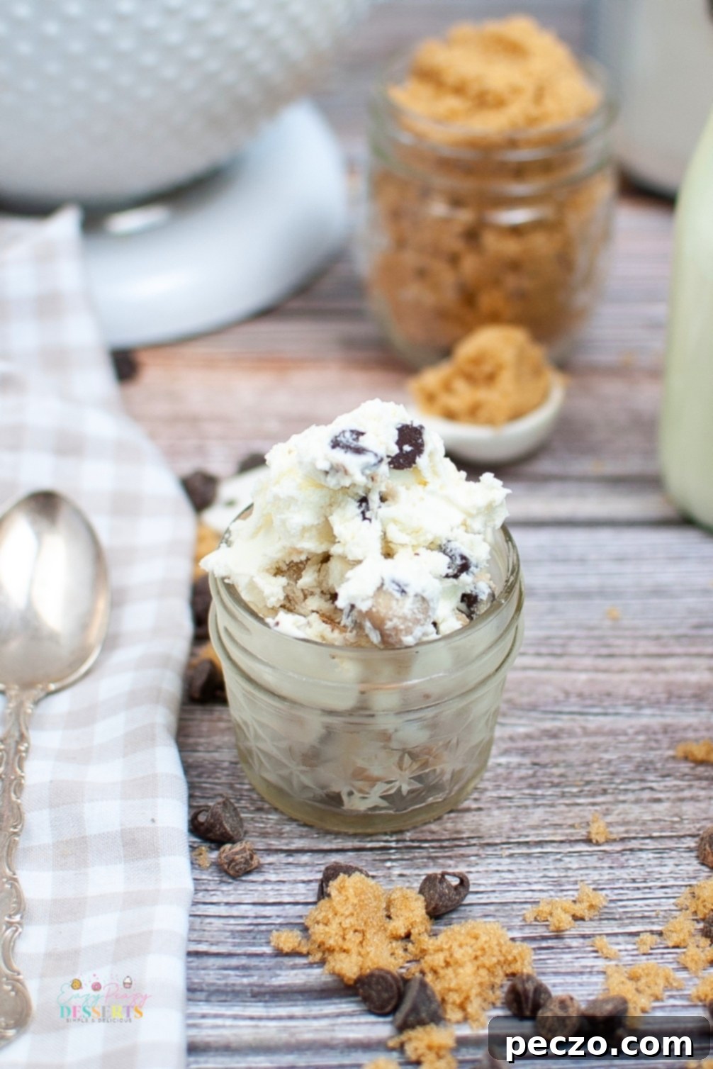 Close-up of a jar filled with decadent cookie dough ice cream, garnished with chocolate chips