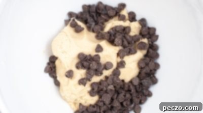 Folding chocolate chips into prepared cookie dough