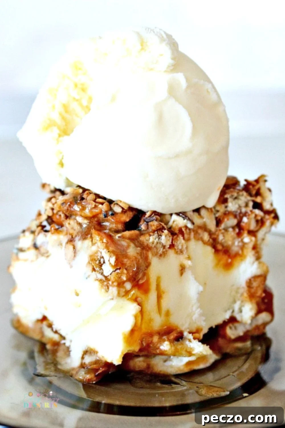 Close up image of ice cream sandwich made with caramel and pretzels and topped with vanilla ice cream