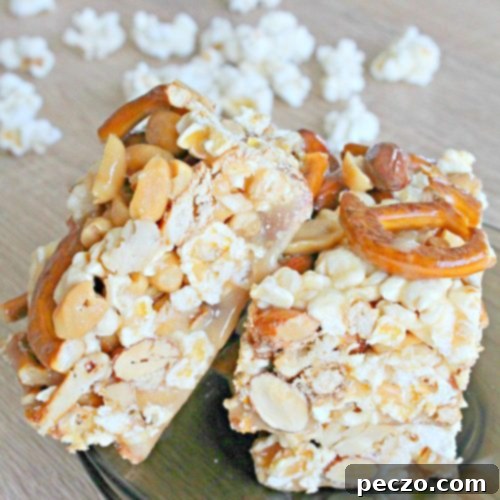 Sweet and Salty Caramel Popcorn Bars 6 Image of 3 bars of popcorn dessert with caramel, pretzel and mixed nuts