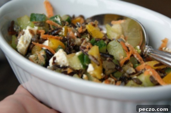 A vibrant, fresh grain and lentil salad in a rustic bowl, ready to be served.